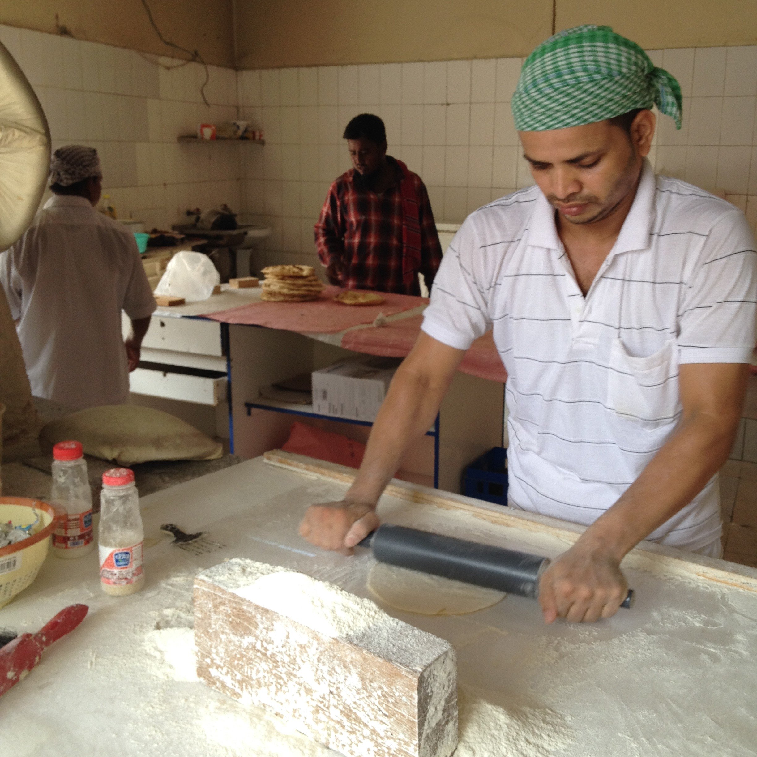 Migrant workers operate the local bakeries in Bahrain. In the Gulf region, these bakeries offer their fresh bread at cheap rates than the packaged bread sold in supermarkets. Bakers endure working around high temperature stone chambers all day, taking breaks from work only for prayers. 